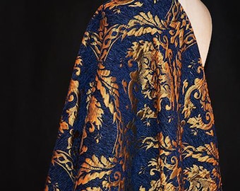 May include: Blue fabric with a gold and orange floral pattern. The fabric has a textured, brocade-like appearance.