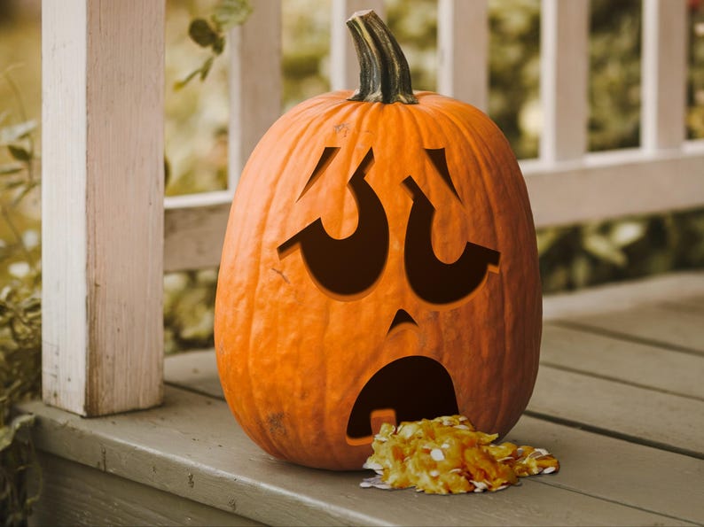 May include: A carved pumpkin with a distressed facial expression, with its mouth open and a pile of orange candy spilling out.