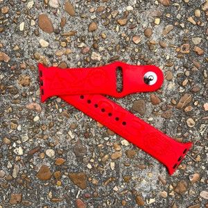 May include: Red Apple Watch band with a Greek letter design and the words "Due Diligence" and "1913 Indstructible".