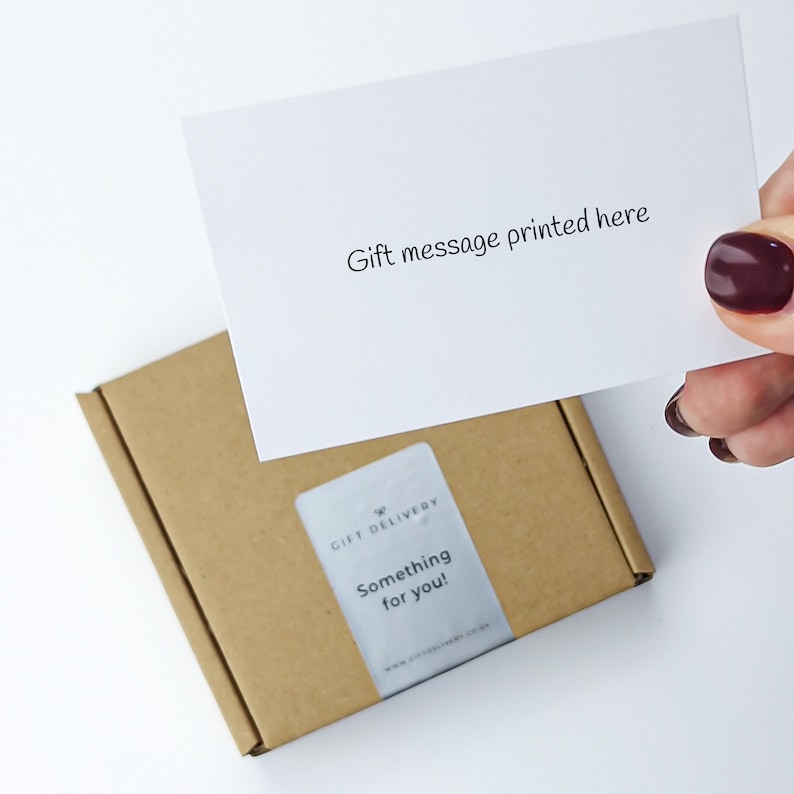 May include: A small, brown cardboard box with a white card that reads "Gift message printed here." A sticker on the box says "Something for you!" and "Gift Delivery."