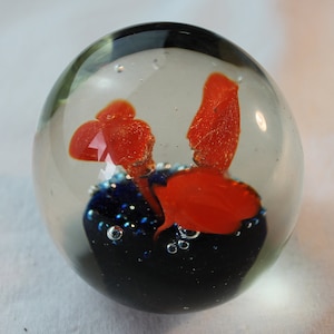 Glass Paperweight; blue and orange flower design, beautiful and collectible.