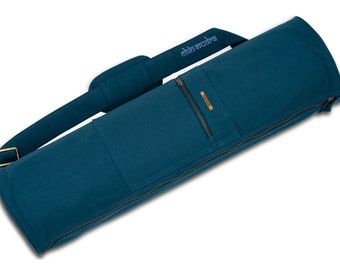 May include: Teal yoga mat bag with a shoulder strap and a full-length zipper. The bag has a rectangular shape with a padded shoulder strap and a small pocket. The text "Chin Mudra" is printed on the strap. The bag is made of a durable fabric.