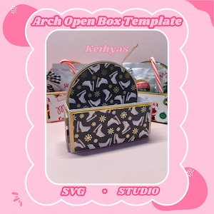 May include: An arch-shaped open box template with a black background and a pattern of white ice skates and gold snowflakes. The box has a gold trim and the text "Arch Open Box Template" is at the top.