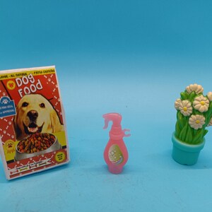 Barbie doll accessories, dog food bag, potted daisies, spray bottle. 90s