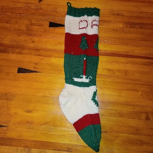 Hand knit dad, christmas stocking, candles, wreath, trees, red, green