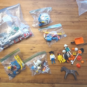 Lot of playmobil toys. incomplete hospital 3495, ice cream cart 3563, horse sled 3391, sandbox 3308, and snowman 3829, cowboy, sheriff,