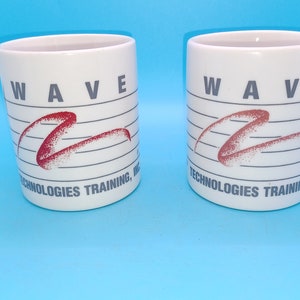 May include: Two white ceramic mugs with a red wave design and the text "WAVE TECHNOLOGIES TRAINING, INC." printed on the front.