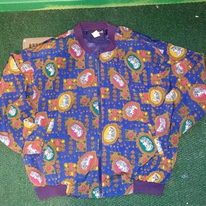 May include: A blue, yellow, red, and white patterned bomber jacket with a zipper closure.