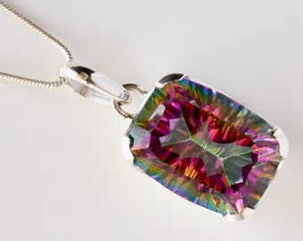 May include: A silver chain necklace with a large, faceted, iridescent gemstone pendant. The gemstone is a rectangular shape and has a rainbow of colors, including pink, green, and blue.