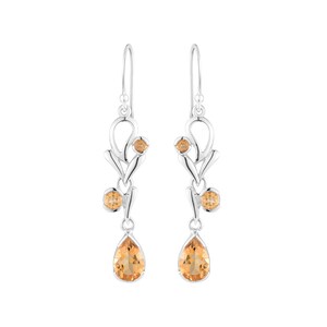 May include: Silver dangle earrings with a floral design and teardrop-shaped topaz gemstones.