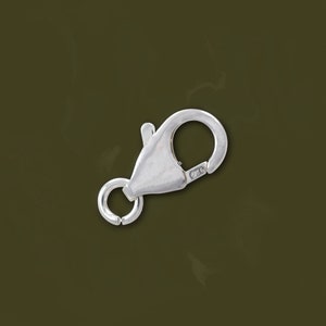 May include: Silver lobster clasp with a spring ring closure. The clasp is marked with "925" indicating sterling silver.