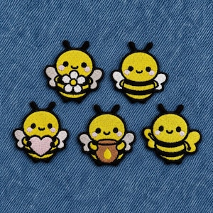 May include: Five embroidered bee patches featuring yellow and black bodies with white wings and pink cheeks. One bee holds a white flower, one holds a pink heart, one holds a brown honey pot, and two are plain bees with black stripes.