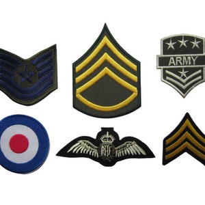 May include: Six embroidered patches, including a blue and white target, a green and yellow chevron, a silver and white chevron with the word "ARMY", a blue and white chevron with a star, a green and yellow chevron, and a black and yellow chevron.