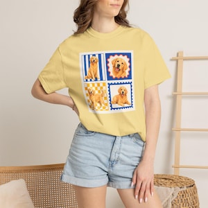 Peut inclure: Un t-shirt à manches courtes jaune pâle avec une impression graphique carrée sur la poitrine. Le motif se compose de quatre panneaux distincts, chacun représentant un chien golden retriever dans différentes poses sur des fonds à motifs.
