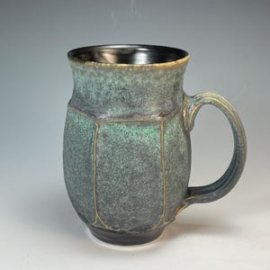 hand thrown porcelain faceted mug 5x5x3.5 with matt blue glaze, satin matt black inside fired in reduction to 2200 degrees F in gas kiln
