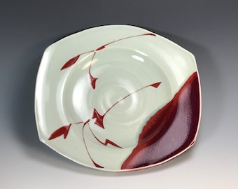rectangular low porcelain bowl 9x8.5x3 with brushwork under celadon and copper red glazes fired in reduction to 2200 degrees F in a gas kiln