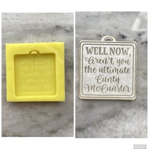 May include: A white wooden sign with the text "WELL NOW, Aren't you the ultimate Cunty McCunster" in a cursive font.