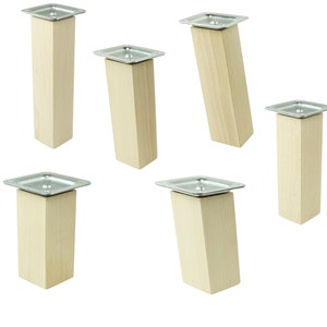 Könnte beinhalten: Fünf Möbelbeine aus Holz mit Metallplatten. Die Beine sind hellbraun und die Platten sind silberfarben.