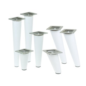 May include: Set of eight white furniture legs with a silver metal top. The legs are tapered and have a square base.