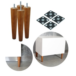 May include: Four wooden legs with metal mounting plates, shown assembled on a white cabinet with a drawer. The cabinet is on a gray surface.