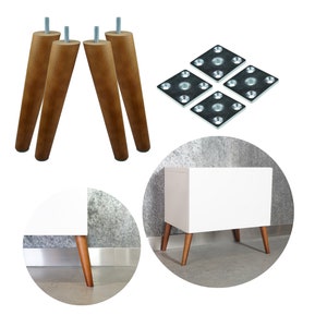 May include: Four wooden legs with metal mounting plates, shown assembled on a white cabinet. The cabinet is shown in two different angles, one with the cabinet against a wall and the other with the cabinet on a gray surface.