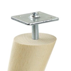 May include: A wooden furniture leg with a metal screw and plate attachment. The leg is light brown and the metal is silver.