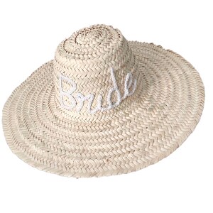 May include: A straw sun hat with a wide brim and the word "Bride" embroidered in white on the front.