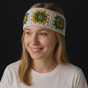 May include: Cream-colored crochet headband with three flower motifs in shades of yellow and green. The headband is made of a chunky yarn and is worn across the forehead. The background is a solid black.