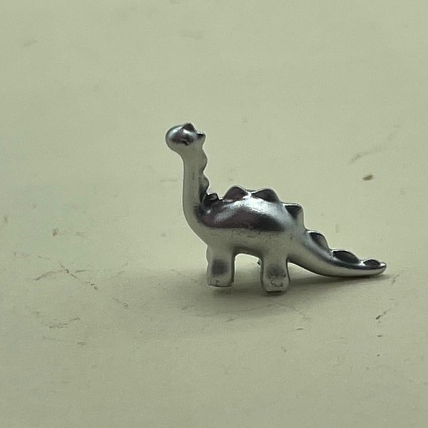 Tiny miniature dinosaur for a dolls house bedroom toy