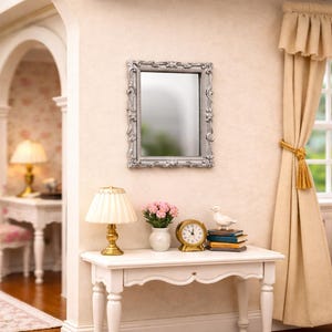 May include: A miniature interior scene with a silver-framed mirror, a white table with a lamp, a vase of pink flowers, and a small clock. The room has beige walls, a window with curtains, and a glimpse of another room.