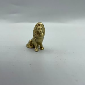 Detailed miniature sitting lion statue