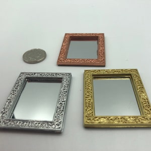 May include: Three ornate decorative mirrors with silver, gold, and copper frames. The mirrors are all the same size and shape, and they have a classic, elegant design.