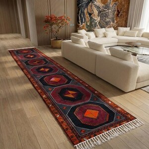 a modern living room with a large white sectional sofa, a colorful rug, and a wooden floor.