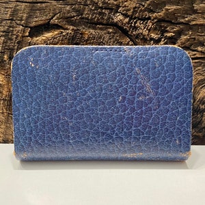 May include: A blue leather-bound box with a textured surface.