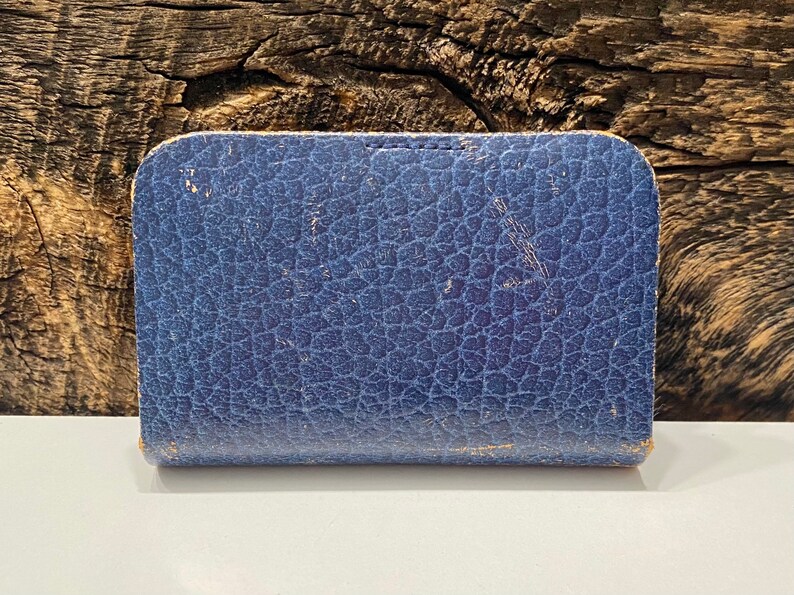 May include: A blue leather-bound box with a textured surface.