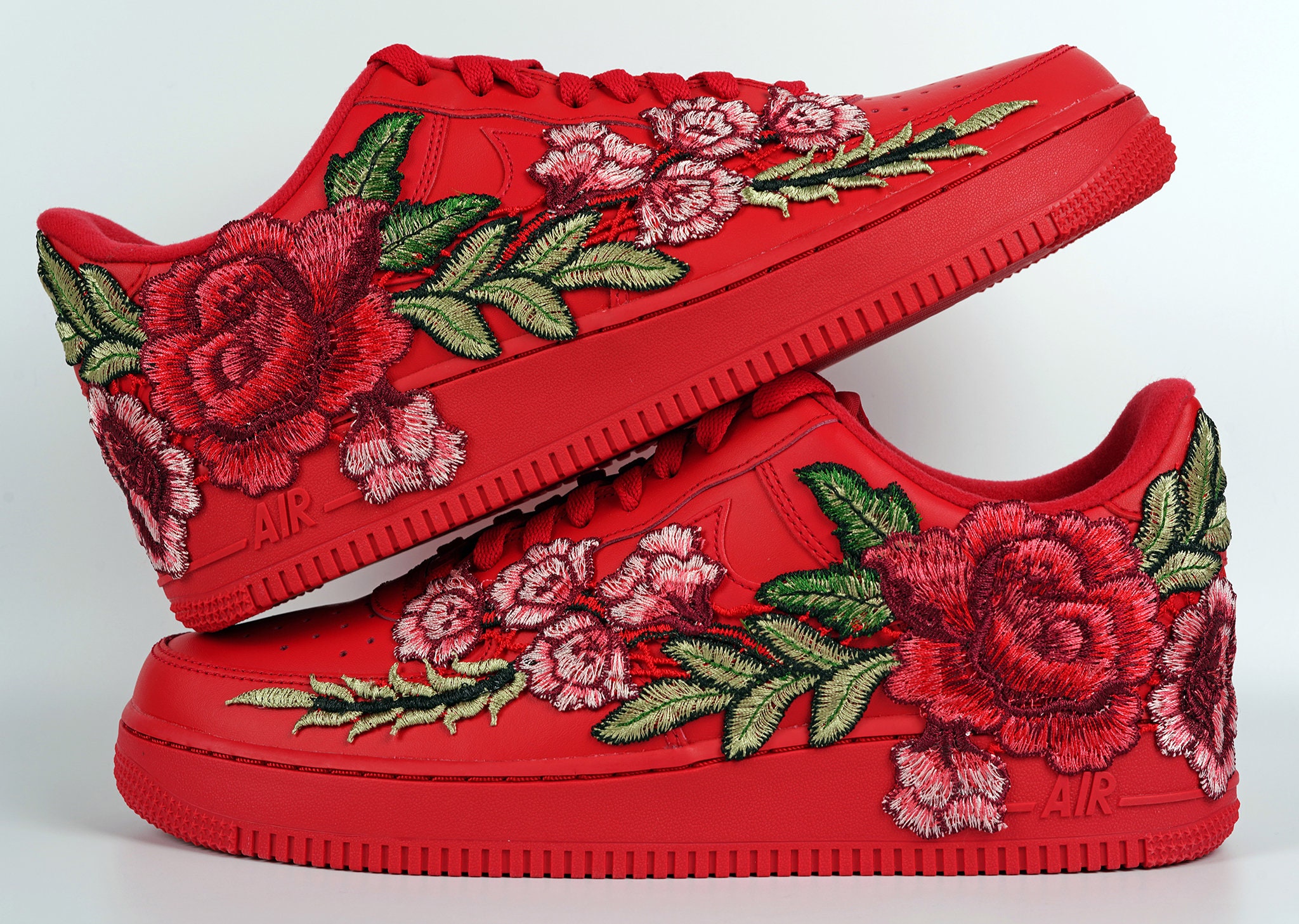 red nikes with roses