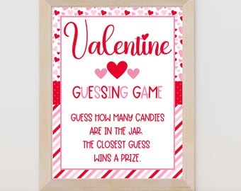 May include: A printable Valentine's Day guessing game sign with a red heart and the text "Valentine Guessing Game" in red. The sign instructs players to guess how many candies are in a jar, with the closest guess winning a prize.