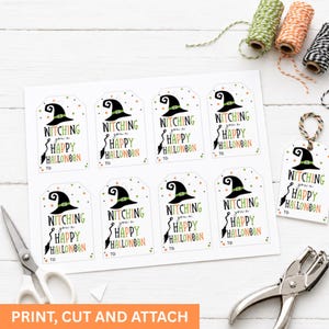 Printed sheet of eight Halloween tags beside scissors, a hole punch, twine, and one finished tag ready to attach.
