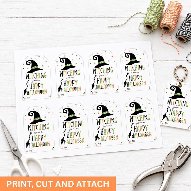 Printed sheet of eight Halloween tags beside scissors, a hole punch, twine, and one finished tag ready to attach.