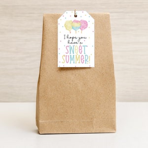 May include: A white gift tag with a colorful cotton candy illustration and the text "I hope you have a sweet summer!"