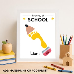 Framed First Day of School footprint keepsake printable displayed on a classroom desk.