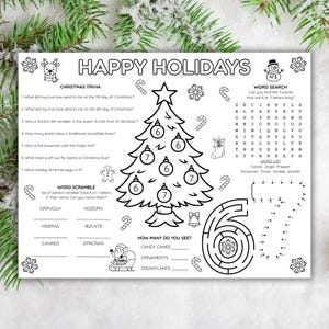 May include: Black and white Christmas activity placemat with trivia, word search, word scramble, and counting games. Features a Christmas tree, snowflakes, candy canes, and the words "Happy Holidays".