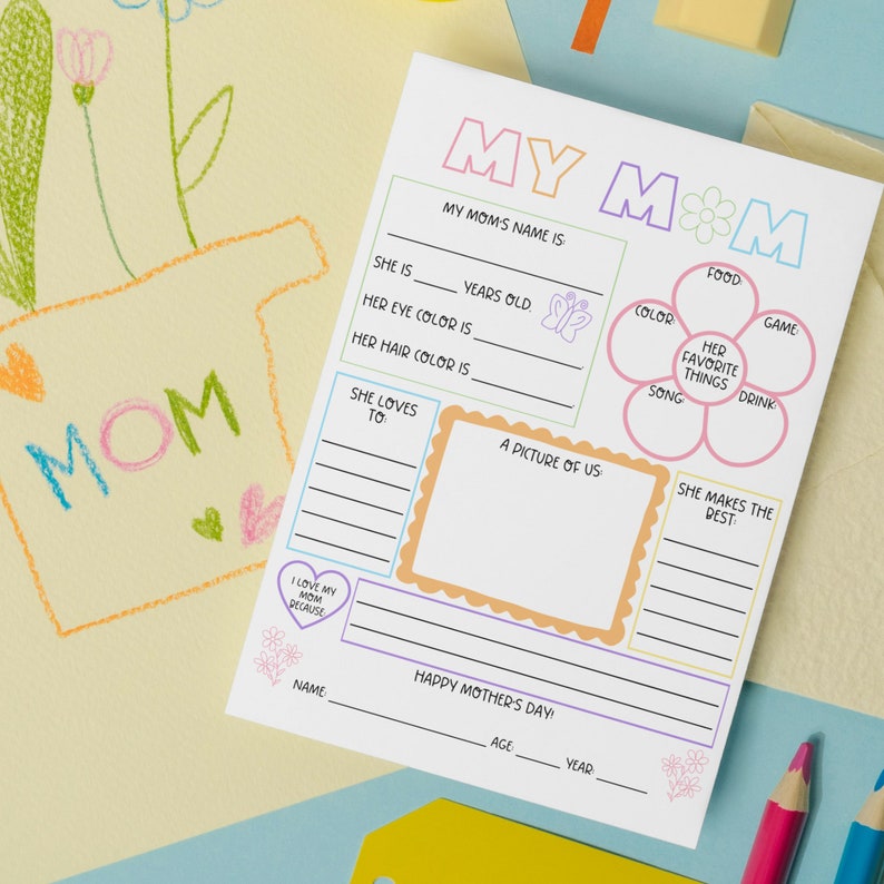 May include: A printable Mother's Day activity sheet with a colorful flower design and prompts for kids to fill in about their mom. The sheet includes prompts like "My Mom's Name Is", "She Is ___ Years Old", "Her Eye Color Is", "Her Hair Color Is", "She Loves To", "Her Favorite Things", "She Makes The Best", and "I Love My Mom Because".