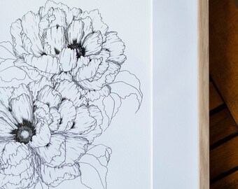 May include: Black and white floral line art print of two peony flowers. The artwork is framed in a light wood frame with a white mat. The detailed drawing features intricate petal and leaf outlines.