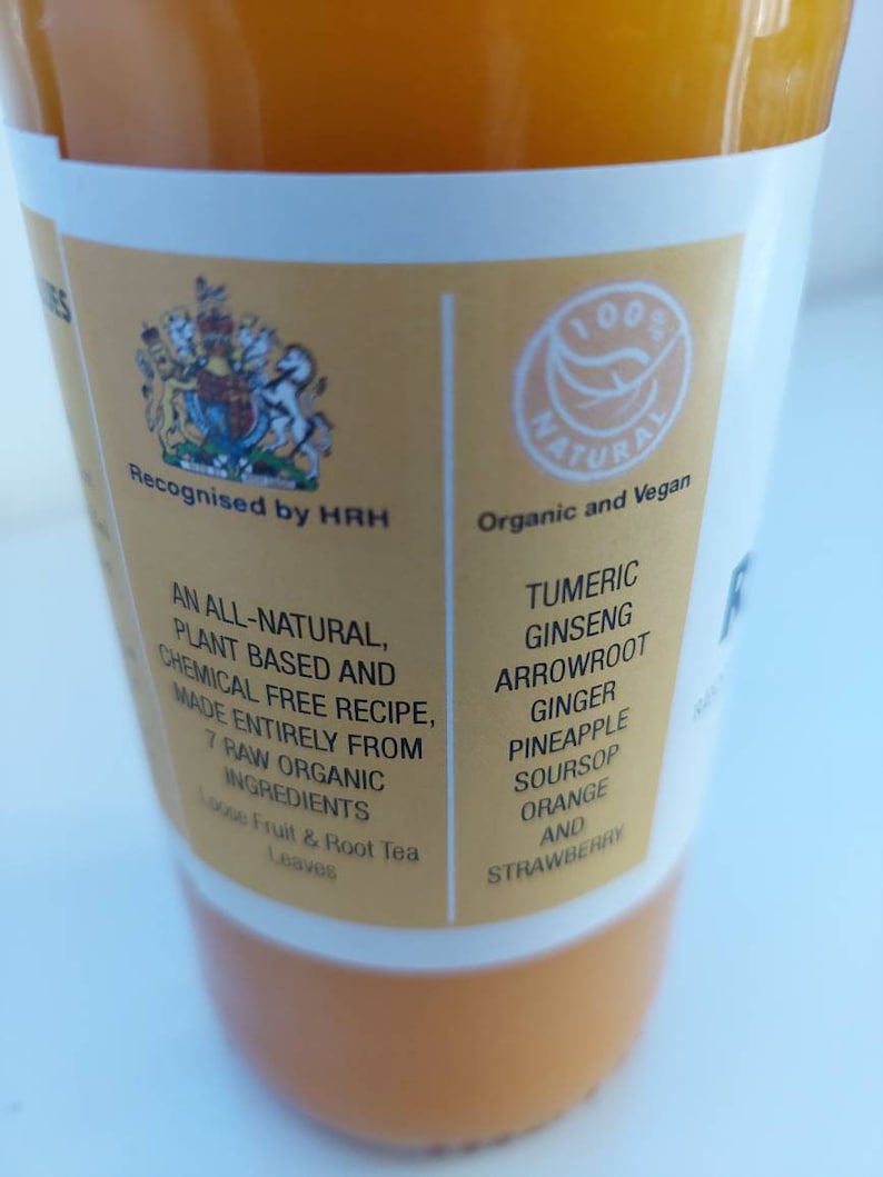 May include: A yellow bottle of juice with a white label. The label says "Recognised by HRH" and "Organic and Vegan". The ingredients listed are: Tumeric, Ginseng, Arrowroot, Ginger, Pineapple, Soursop, Orange, and Strawberry.