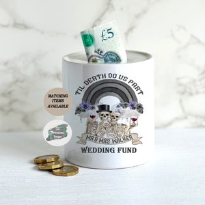 May include: White ceramic piggy bank with a black and white illustration of two skeletons holding wine glasses. The text "Til Death Do Us Part" is written in a black gothic font above the skeletons. The text "Mr & Mrs Walker Wedding Fund" is written below the skeletons.
