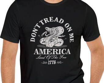 May include: Black t-shirt with a white graphic of a coiled snake with the text "Don't Tread On Me" and "America Land Of The Free 1776".