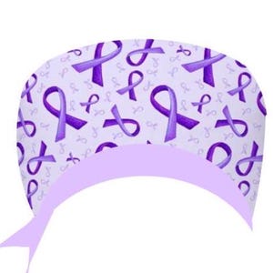 May include: A light purple surgical scrub cap featuring a pattern of purple awareness ribbons. The cap has a light purple band and ties. The ribbons represent support for different causes.