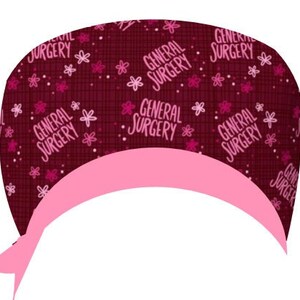 May include: A burgundy scrub hat with a pink trim and a repeating pattern of pink flowers and the words "General Surgery".