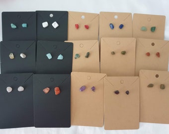May include: Assortment of 10 pairs of gemstone earrings displayed on small cards. The earrings are made of various natural stones, including turquoise, white, red, blue, green, amethyst, and brown.